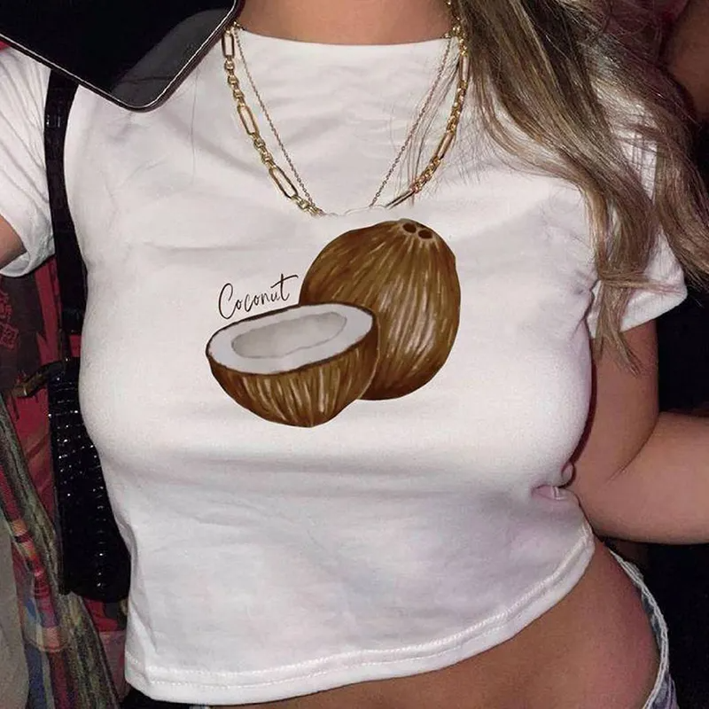 Woman wearing a white baby tee with a coconut graphic print, cropped slim fit, Y2K aesthetic style.
